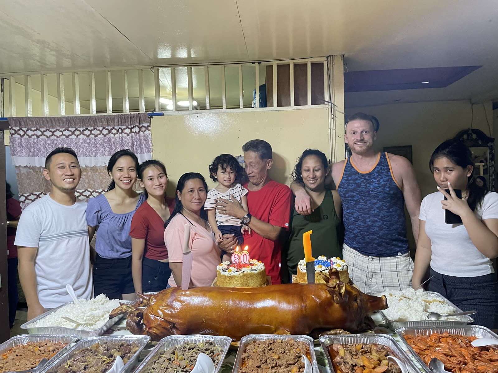 Family gathered around lechon at a birthday celebration