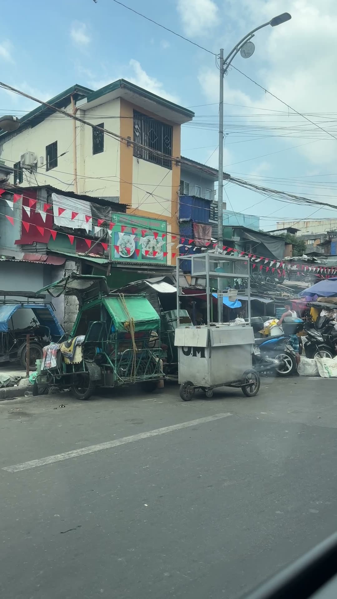 Neighborhood street with tricycles and sari-sari stores